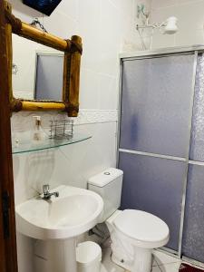 a bathroom with a toilet and a sink and a shower at Cantinho Pilar in Ouro Preto +10 photos