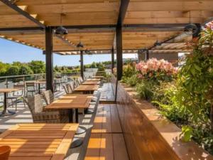 a row of tables and chairs on a patio at Bliss on the Bay at Waterside Holiday Park in Paignton