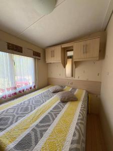 a bedroom with a bed with two pillows on it at MONTDOU'Gîte in Montdoumerc