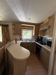 a small kitchen with a table and a counter top at MONTDOU'Gîte in Montdoumerc +7 photos