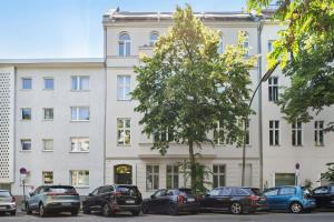 a large white building with cars parked in front of it at Modern Apartment in Berlin in Berlin