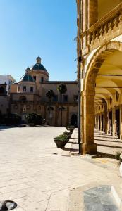 a building with an archway in a courtyard at Da Liliana Apartment in Mazara del Vallo +56 photos
