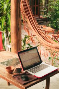 a laptop computer sitting on a hammock on a table at Taba Maraú in Marau +5 photos