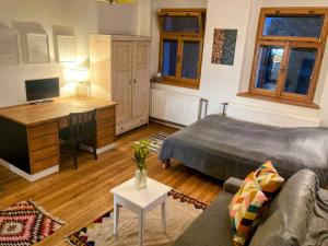 a living room with a couch and a desk at Apartmán Nortico in Nový Bor