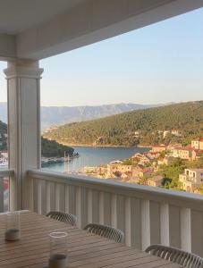 a balcony with a table and a view of the water at Apartment Maestral, Pucisca ,Island Brac in Pučišća