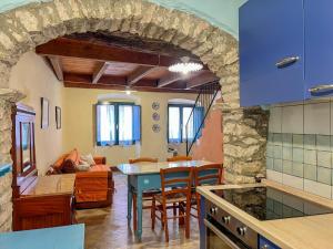 a kitchen and living room with a table and chairs at Sardinian Gallery Bonaria in Bosa