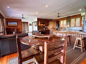a living room with a table and a bar at The Nature Nook in Vanderbijlpark
