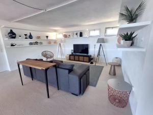 a living room with a couch and a table at Villa 5 BDs Breathtaking Views Large Pool Jacuzzi in Carqueiranne +15 photos