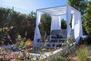 a gazebo with a bed in a garden at Villa 5 BDs Breathtaking Views Large Pool Jacuzzi in Carqueiranne