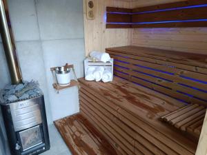 a room with a woodburning stove in a cabin at Miętowy domek in Jagodne
