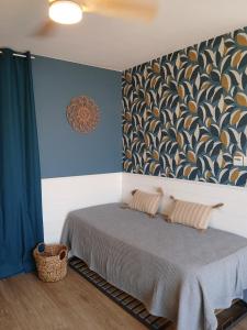 a bedroom with a bed with a wall mural at Front de mer - Le Barcarès in Le Barcarès