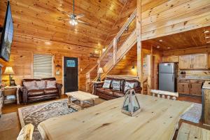 a living room with a table in a cabin at Hickory Haven By Avada Properties in Gatlinburg