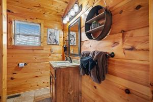 a bathroom with a sink and a mirror at Hickory Haven By Avada Properties in Gatlinburg +37 photos