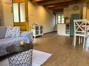 a living room with a couch and a table at Apartment Abinkar in Tolmin
