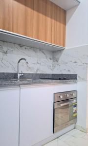 a kitchen with a sink and a counter top at Marina Bay Elegance Room Balcony Overlooking Luxury Yachts in Hurghada