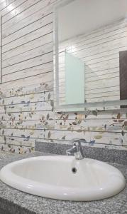 a white sink in a bathroom with a mirror at Marina Bay Elegance Room Balcony Overlooking Luxury Yachts in Hurghada +18 photos