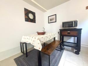 a room with a table and a clock on the wall at Casa Alameda in Alameda