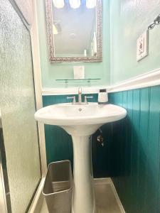a bathroom with a white sink and a mirror at Casa Alameda in Alameda +22 photos