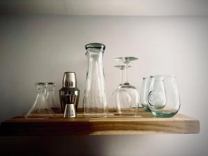 a shelf with different glass bottles on it at Casa Alameda in Alameda