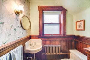 a bathroom with a sink and a mirror at 2 Mi to Lake Erie Spacious Retreat Near Cafes! in Erie