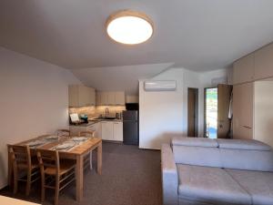 a living room and kitchen with a table and a couch at Župky in Županovice