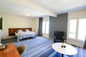 Postel nebo postele na pokoji v ubytování Østergaards Hotel