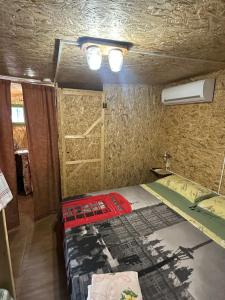a bedroom with a bed in a room with a wall at Case vacanza Centro estivo Il Catauso in Sonnino