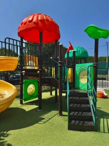 a playground with a slide in a park at FishLand Seaside Apartments in Durrës +71 photos