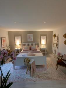 a bedroom with a large bed and two lamps at La Maison d'Arlette - Maison d'Hôte et Gite au coeur de l'Isère à 10 mn de Voiron, capitale de la Chartreuse, et du Lac de Paladru in Saint-Blaise-du-Buis +157 photos