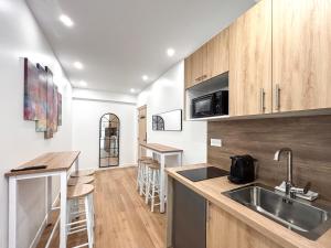 a kitchen with wooden cabinets and a counter top at Villa des Camelias in Le Pré-Saint-Gervais