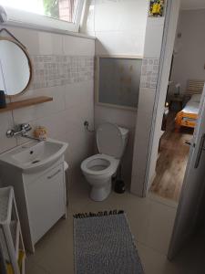 a small bathroom with a toilet and a sink at 117 in Łeba +51 photos