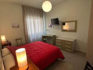 a bedroom with a red bed and a mirror at Mythos Holiday Home in Campobasso +10 photos
