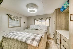 a bedroom with a bed and a sink at Walk to Lake Beaches Cabin with Patio in Belmont! in Belmont