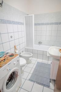 a white bathroom with a washing machine in it at San Giacomo Sweet Home in Nettuno