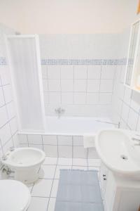 a white bathroom with a toilet and a sink at San Giacomo Sweet Home in Nettuno +22 photos
