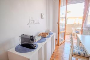 a room with a counter with a microwave on it at San Giacomo Sweet Home in Nettuno