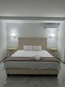 a bedroom with a large bed with two night stands at Hotel The Royalty Inn in Guayaquil
