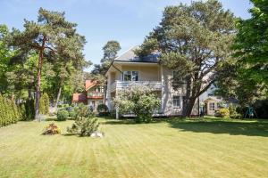 a house with a large yard in front of it at Vila Claudia in Palanga