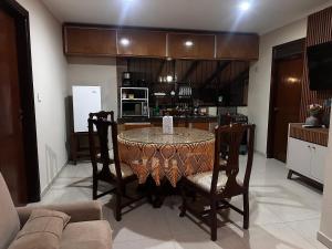 a living room with a table and chairs and a kitchen at Departmento Ametauna in Santa Cruz de la Sierra +6 photos