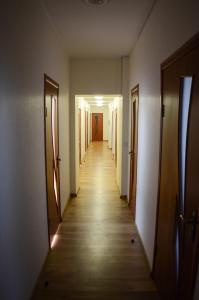 a room with a door leading to a hallway at City Hostel in Kolomiya