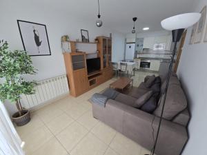 a living room with a couch and a kitchen at MHC in Boiro
