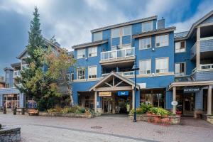 a blue building on a street in a city at 1BR Stylish Condo central Village Location with Private Balcony in Whistler