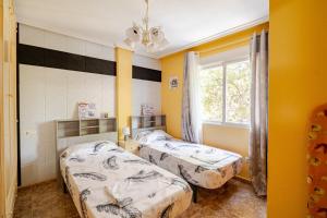 En eller flere senge i et værelse på Tropicana Holiday Home