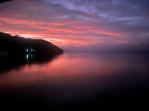 a sunset over a large body of water at Pousada da Estação in Silva Jardim