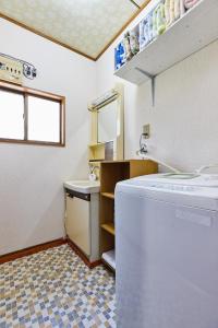 a bathroom with a washing machine and a sink at Sagamihara - House - Vacation STAY 19164 in Sagamihara