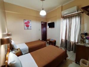 Postel nebo postele na pokoji v ubytování Hotel Anagennisis