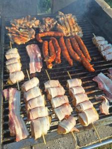 a bunch of different types of food on a grill at Bungalov Veruša in Podgorica