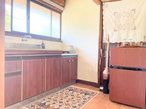 a kitchen with wooden cabinets and a sink and a window at Teshima usagi house - Vacation STAY 56169v in Hama