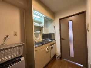 a small kitchen with a sink and a counter at Hare no hi Hakushima - Vacation STAY 94996v in Hiroshima