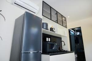 a kitchen with a stainless steel refrigerator and a sink at Villa Mikuri Tsunoshima - Vacation STAY 02198v in Shimonoseki